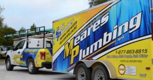 Meares Plumbing truck pulling a company-branded trailer